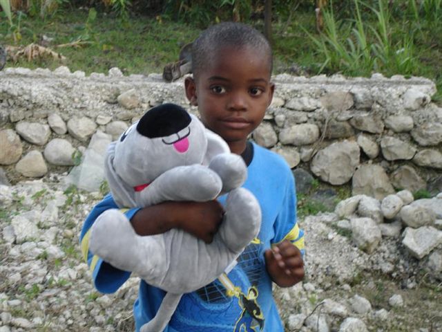 Trouble the Dog with a little boy in Haiti